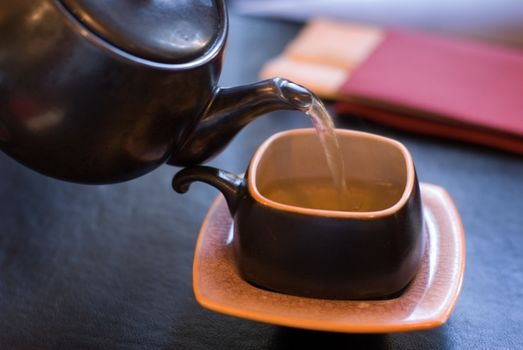 Pouring green tea, shallow depth of field.