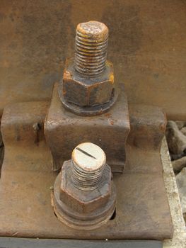 Old rusty railway bolt with nuts 