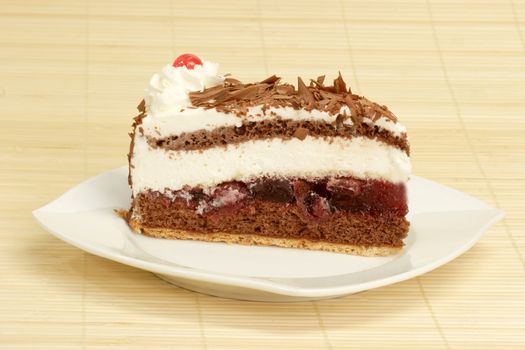 Slice from a delicious Black Forest gateau chocolate, cream and cherry cake.