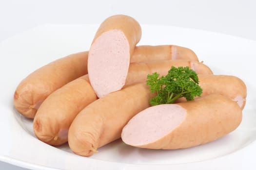 Crrisp cooked sausages on bright background