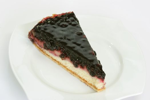 Slice of huckleberry pie on bright background