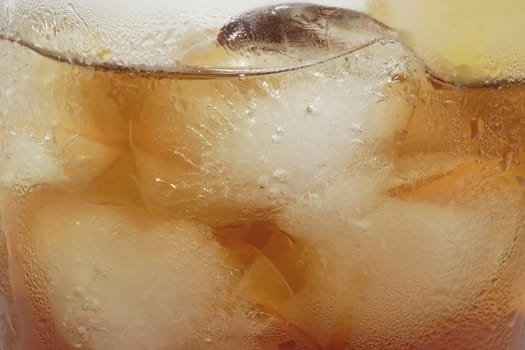 A glass full of Ice Tea in detail as background