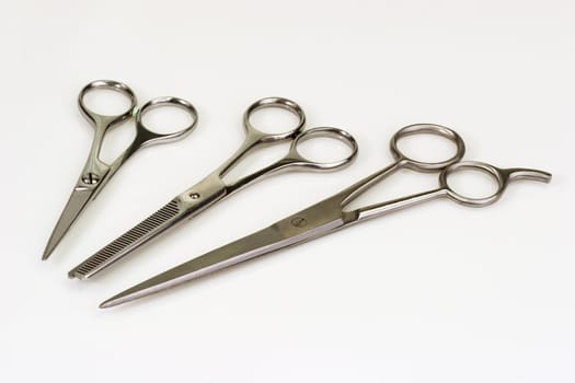 Haircutting scissors on bright background
