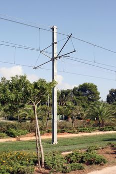 electric train pillar among flowers and plants environmental friendly transportation 