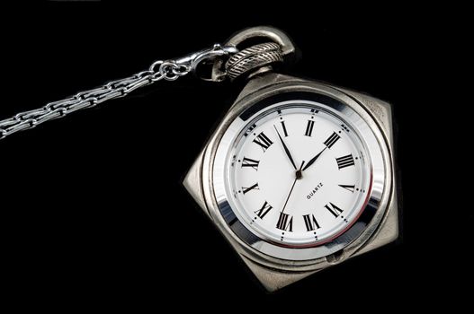 Pentagoned steel pocket watch on black background