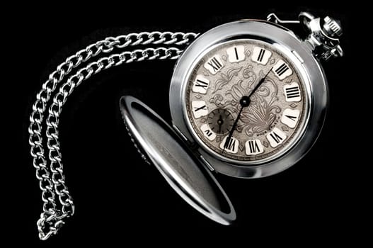 Old pocket watch with chain isolated on black background