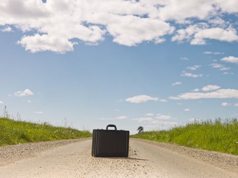 Lonley briefcase on a Dirt Road