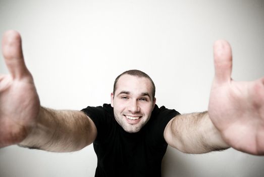 Cheerful man with open arms - focus on the face.