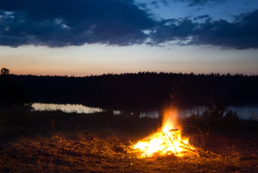 Campfire at dusk. Long exposure. Location: Mazury, Poland.