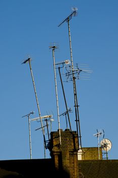 Television antenas on the roof of old building in the London, UK