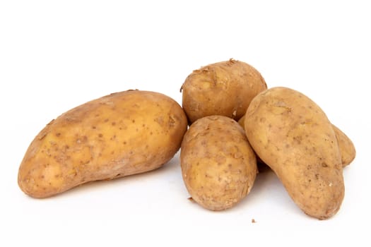 heap raw potatos vegetable root closeup isolated on white background