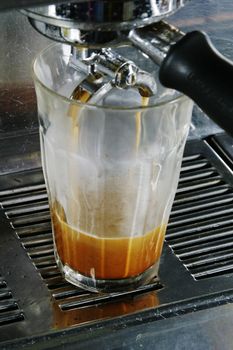 Double latte being extracted from a professional espresso machine.