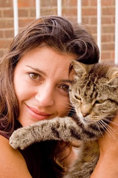 Pretty young woman with a tabby old tomcat 