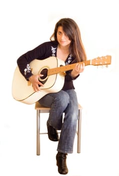 female musician holding an acoustic guitar .