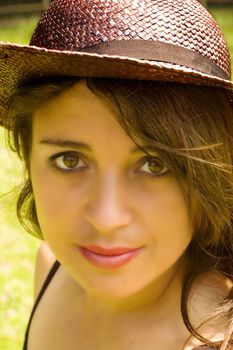 a portrait of an attractive woman wearing a hat.