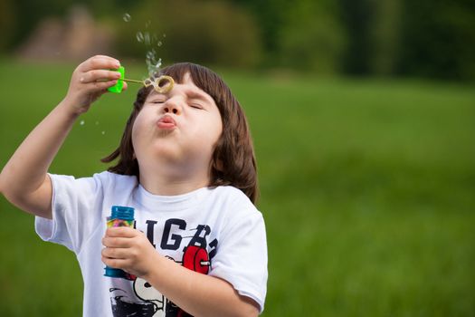 Boy tries to make a soap bubble