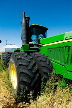 A large air seeder system being pulled behind a John Deere Tractor