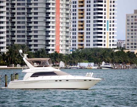 cabin cruiser moored at a Miami Beach condo marina on the florida intercoastal waterway