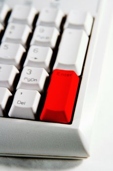 Desktop Computer Keyboard with enter key in red.