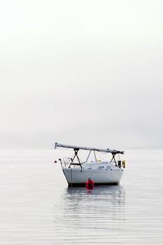 A sail boat in the Oslo Fjord on a foggy day.