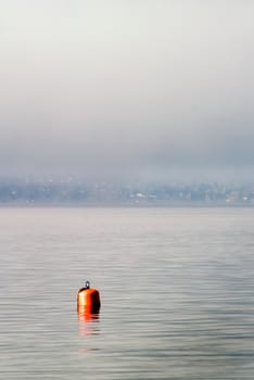 Buoy on a foggy ocean
