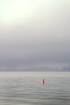 Buoy on a foggy ocean