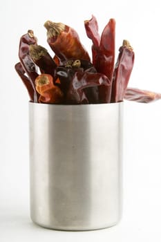 Driec chillies upright in a can.