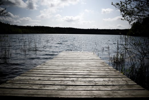 Weathered wooden pier - intentional vignetting and desaturation.