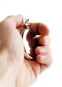 A male hand holding a fancy pocket watch