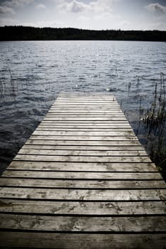 Weathered wooden pier - intentional vignetting and desaturation.