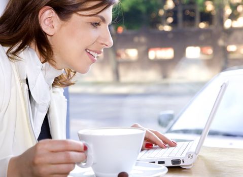 happy businesswoman drinking morning coffee and surfing internet