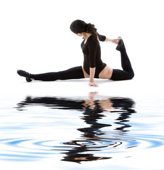 fitness instructor in black leotard on white sand