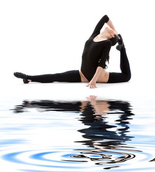 fitness instructor in black leotard on white sand