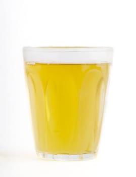 A glass of fresh apple juice isolated on white.