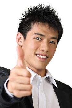 Happy young business man of Asian giving you a thumbs up sign isolated against white.