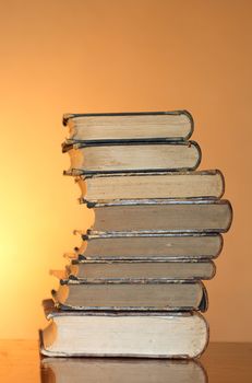 Stack of ancient books isolated on gradient yellow background