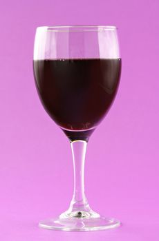 glass of red wine, pink background