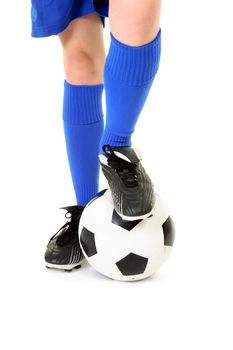 A boy rests his foot on a soccer ball.  White background.