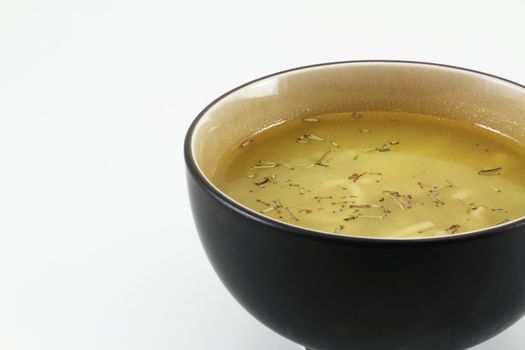 A traditional oriental bowl full or soup with spices.