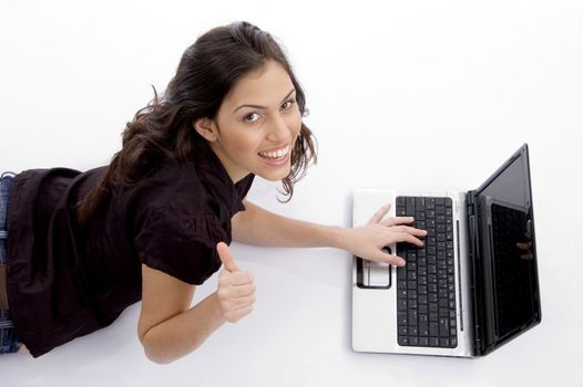 laying woman with laptop and looking upward with white background