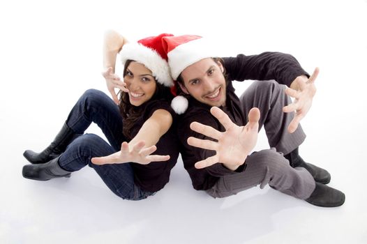 young couple wearing christmas hat with hand gesture on an isolated white background