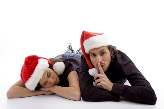 cute girl sleeping and guy indicating for silent on an isolated white background