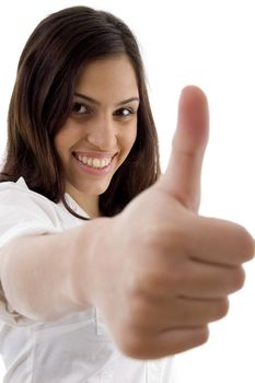 young cute girl showing thumbs up against white background