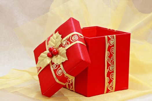 red christmas gift box on gold fabric