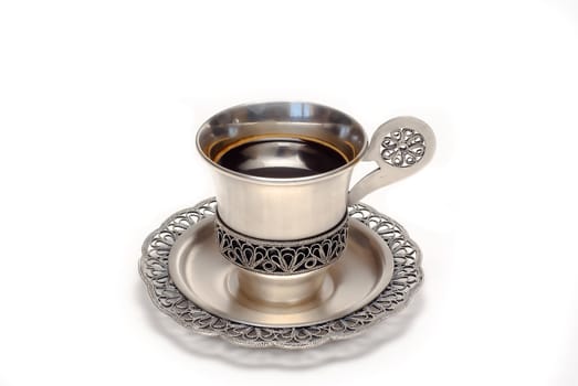 Silver cup of coffee is on the white background