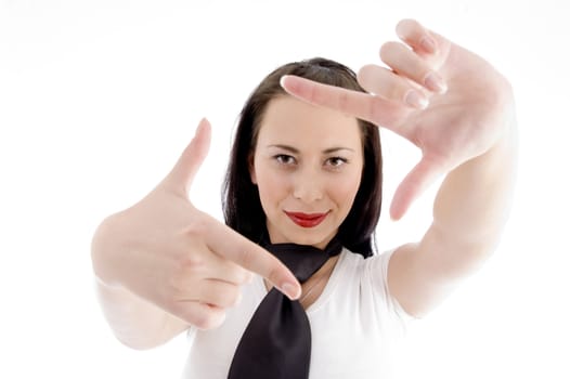 young woman creates a frame with her hands on an isolated background