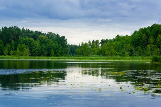 Peaceful lake view - bright interval between rain. Mazury, Poland.