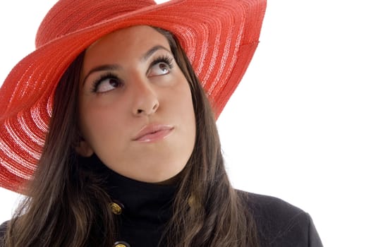 female wearing hat looking upward against white background