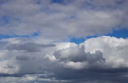 In the blue sky translucent stratose and cumulus clouds