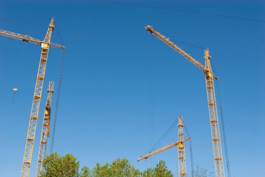 four hoisting cranes and the sky